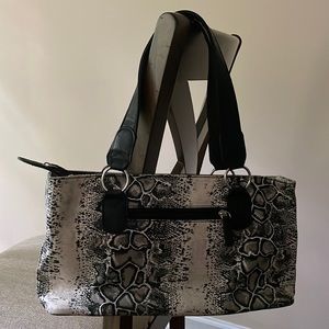 Black and cream purse with black straps. Divider with zipper.